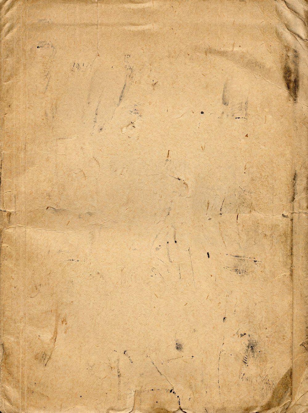 A close-up view of aged, yellowed parchment paper with visible creases, folds, and scattered dark ink splatters.