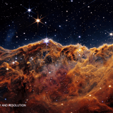 Vivid orange and gold emission nebula with towering cosmic pillars and dense star field – 5K space background