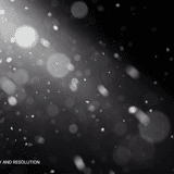 Scattered dust particles with glowing bokeh circles of varying sizes against a black background