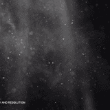 Fine dust and debris particles with soft bokeh light effects floating on a black background