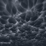 Dramatic dark mammatus storm clouds filling the entire frame – premium 5K sky background