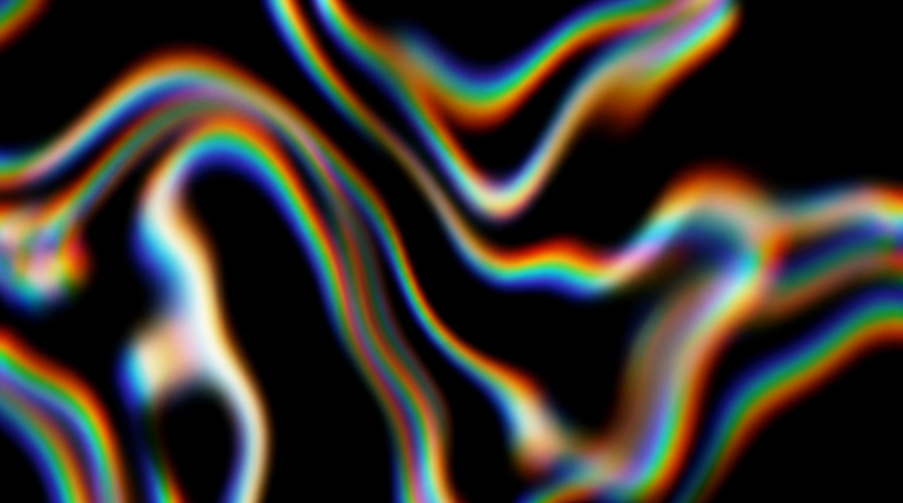 Abstract black background with swirling, blurry waves of rainbow chromatic aberration.