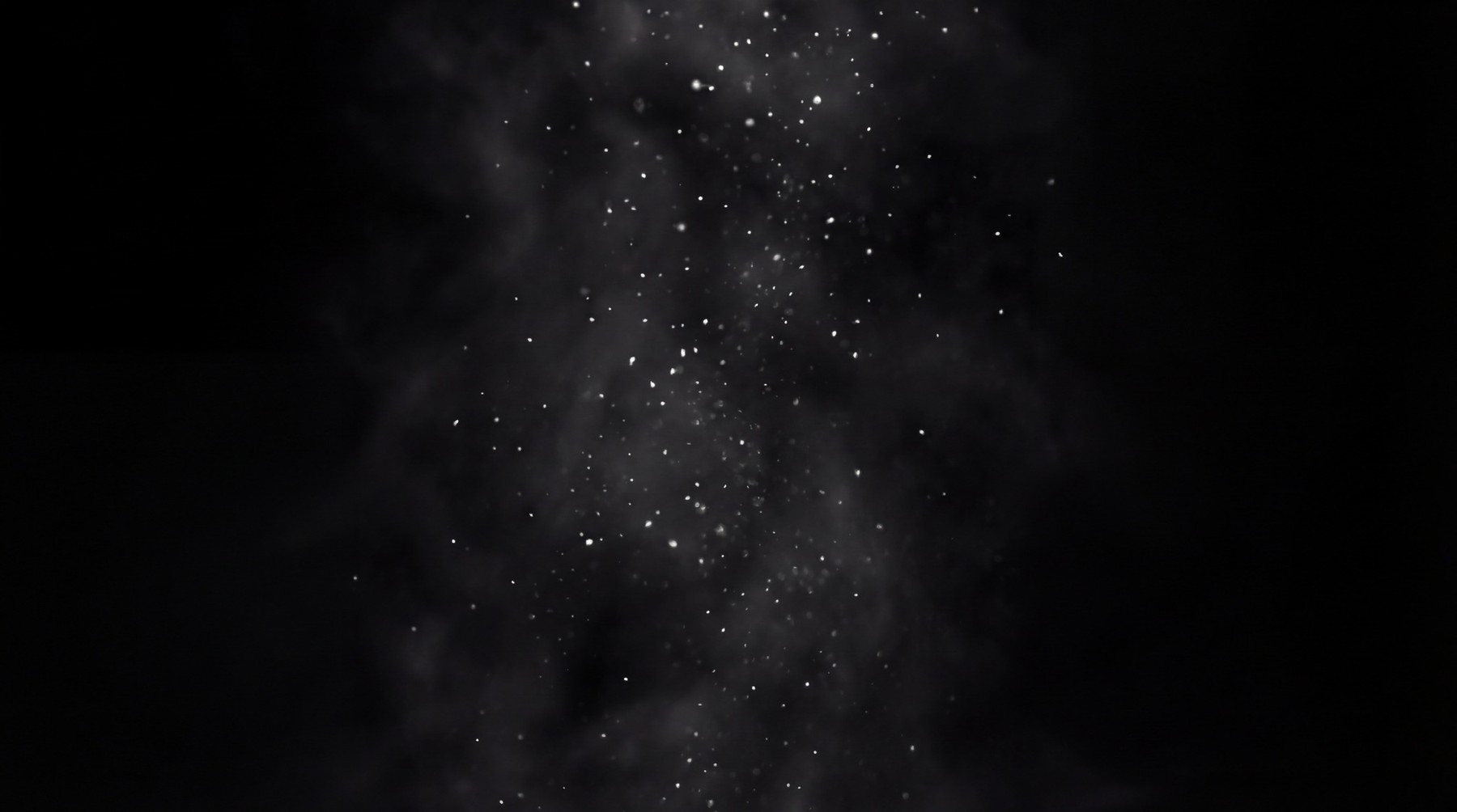 A dark background with a dense plume of white smoke rising from the bottom, filled with numerous small, bright white glitter particles.