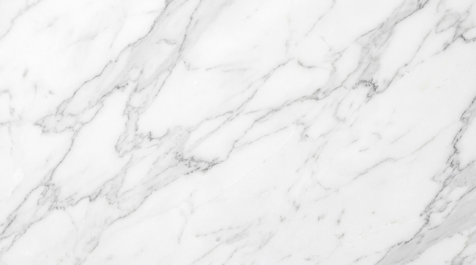 A high-resolution texture of white marble with delicate, intricate grey veining.