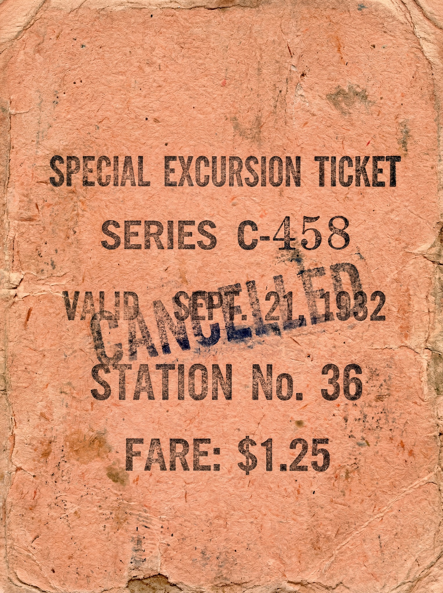 A close-up, textured view of an aged, faded salmon-colored paper ticket with a prominent "CANCELLED" stamp overlay.