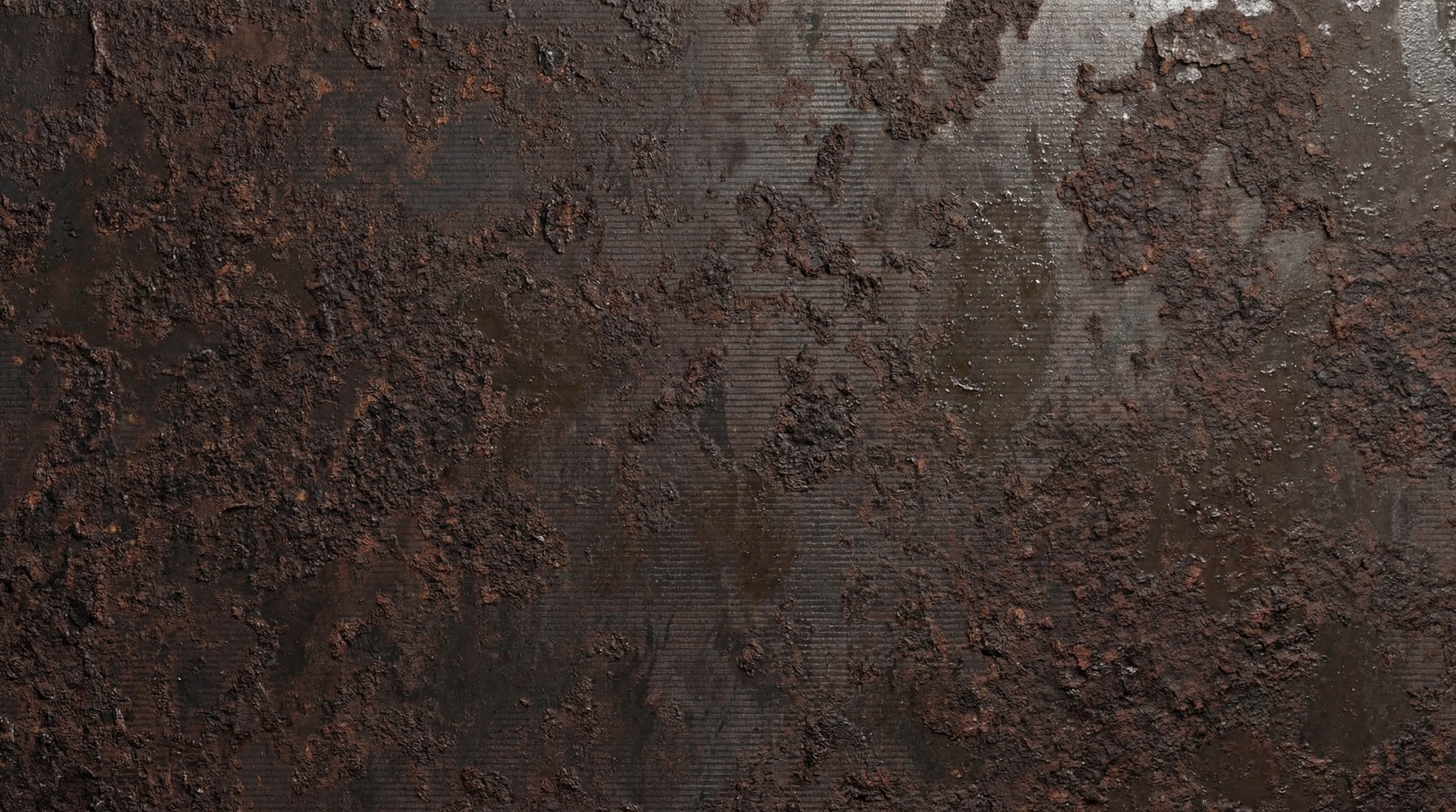 Close-up view of a heavily rusted metal surface with dark brown and reddish-brown textures and fine horizontal lines.