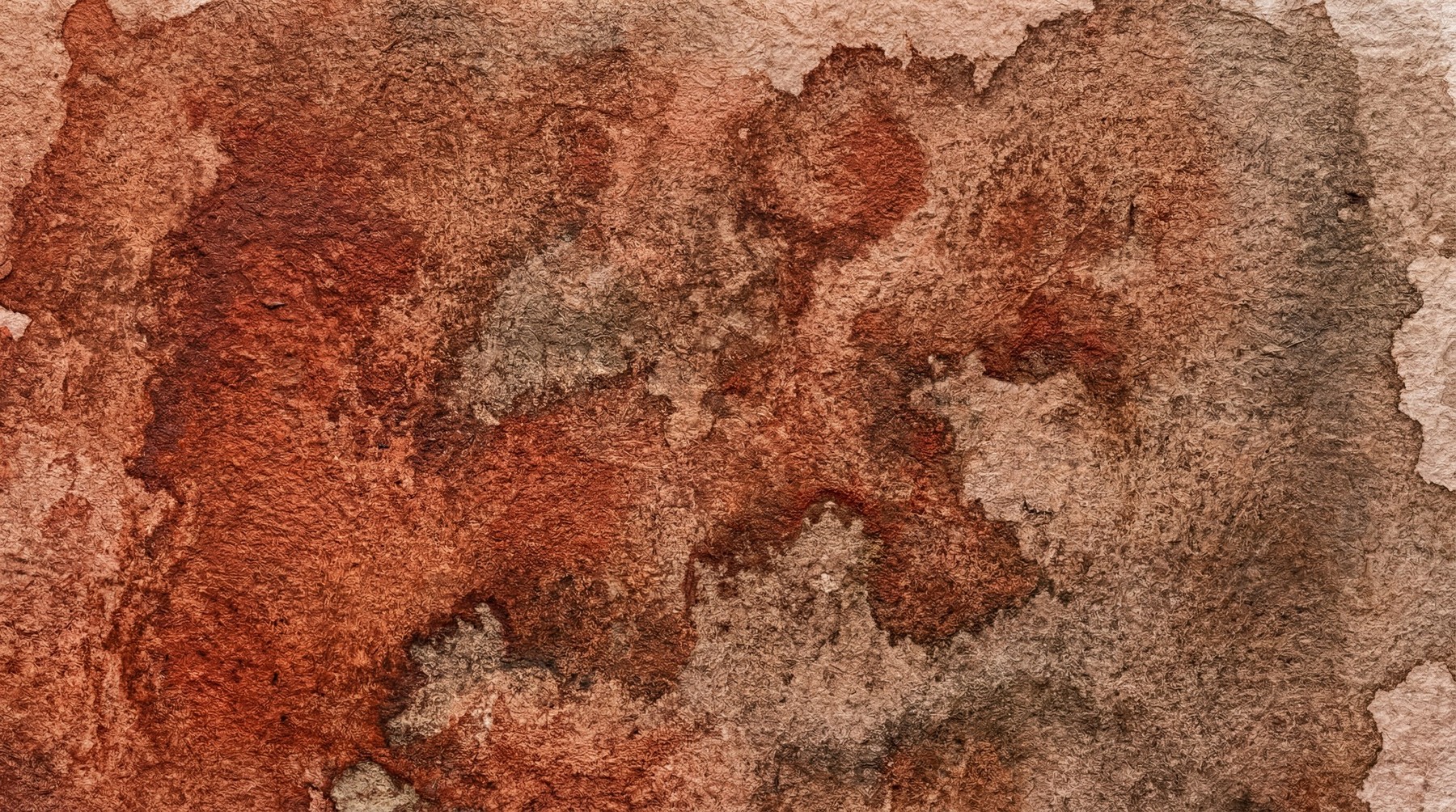 A close-up of an earthy brown watercolor stain with visible texture and pigment variations.