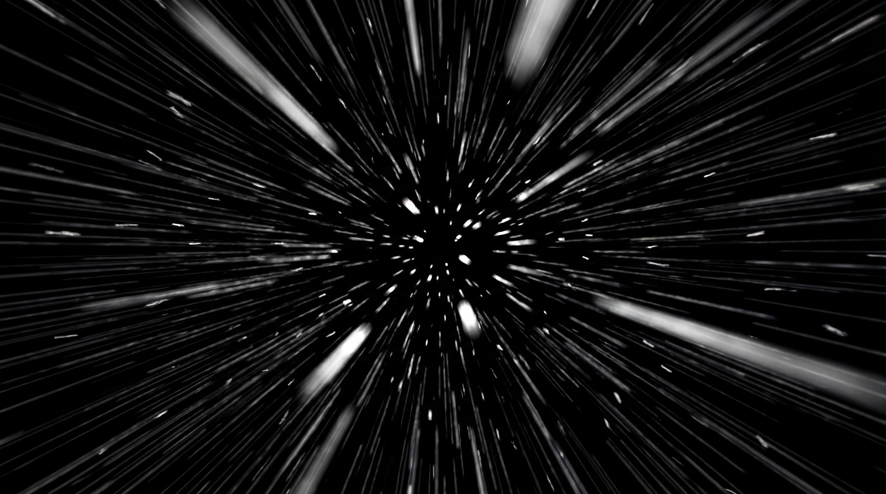 Abstract visualization of hyperspace travel with streaks of light emanating from a central point against a black background.