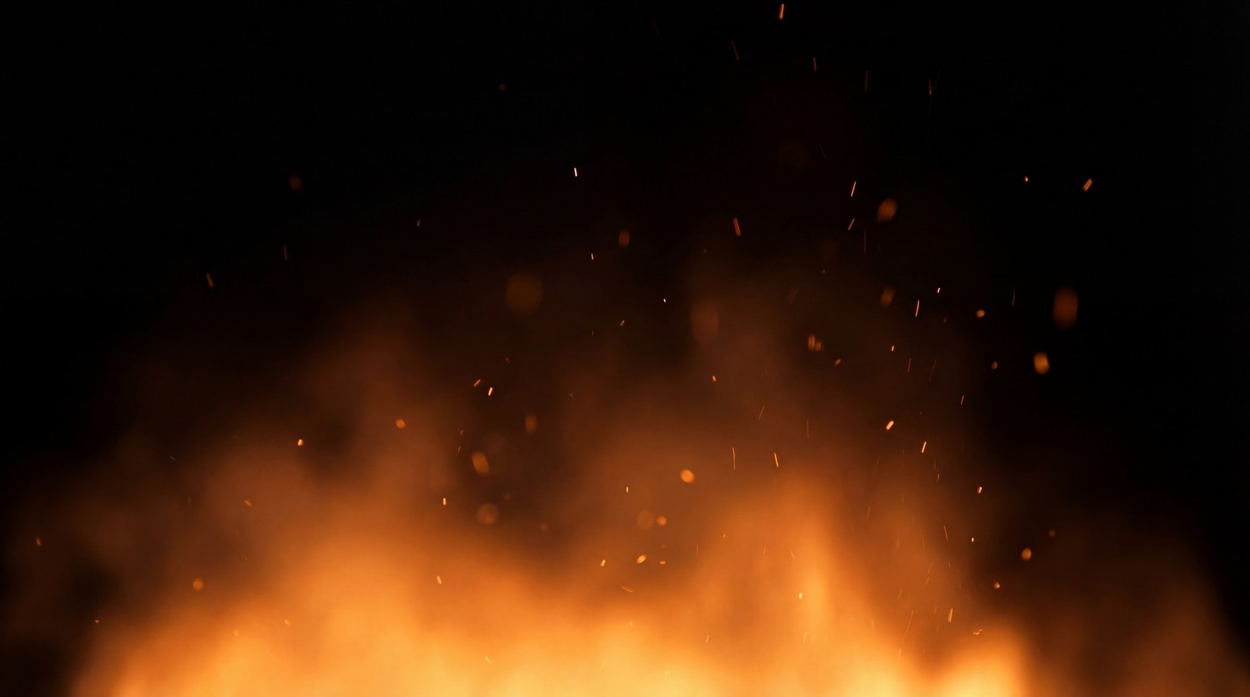 Fiery orange flames with rising embers and smoke against a black background.