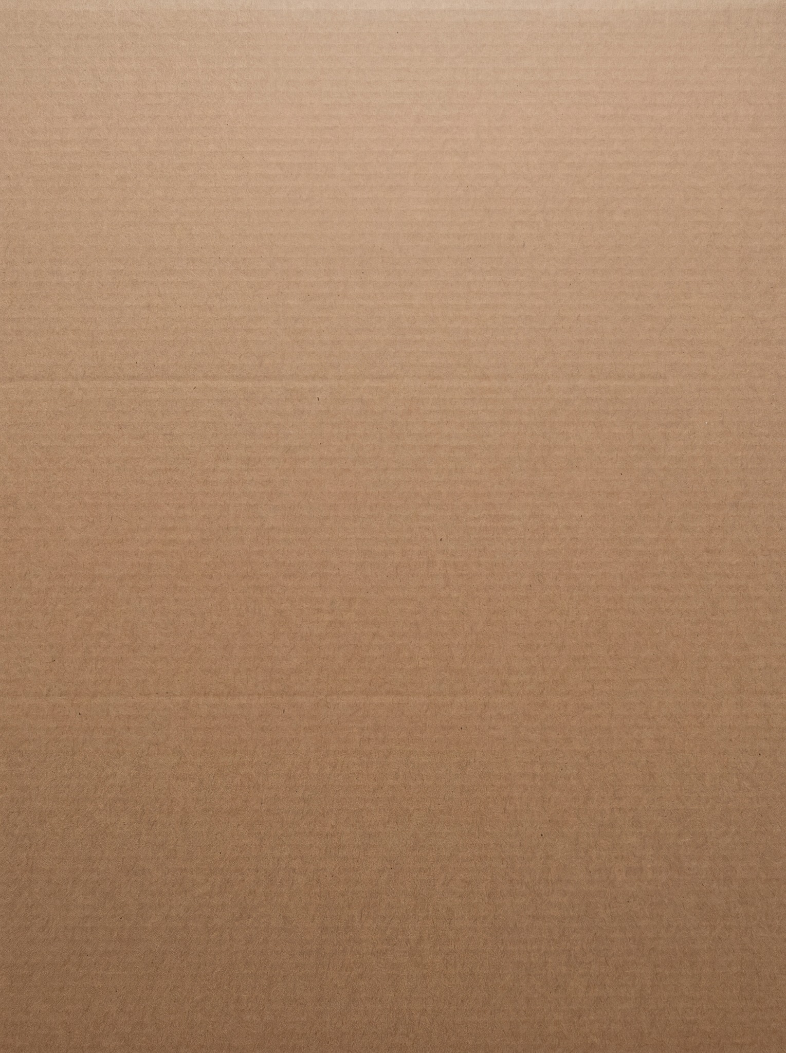 A close-up view of a standard brown corrugated cardboard texture with visible horizontal fibers and subtle lines.