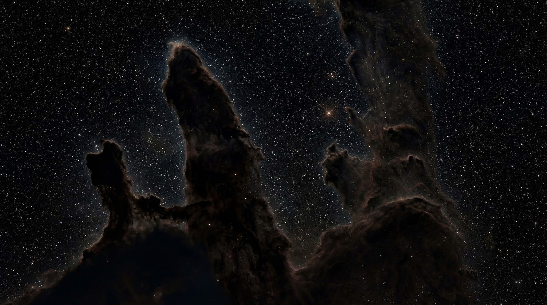 Towering dark nebulae structures, resembling pillars, against a deep black sky densely populated with countless white stars.