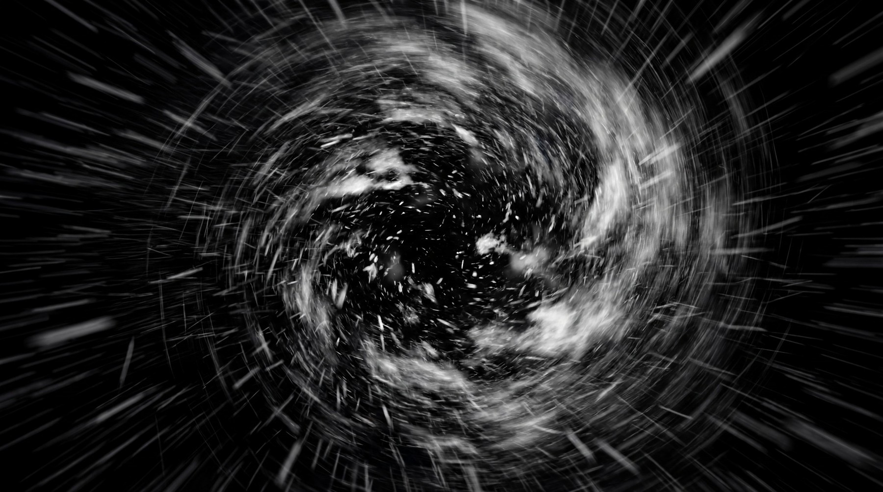 A dynamic, high-intensity snowfall depicted as a swirling vortex against a stark black background, with streaks of white suggesting rapid motion.