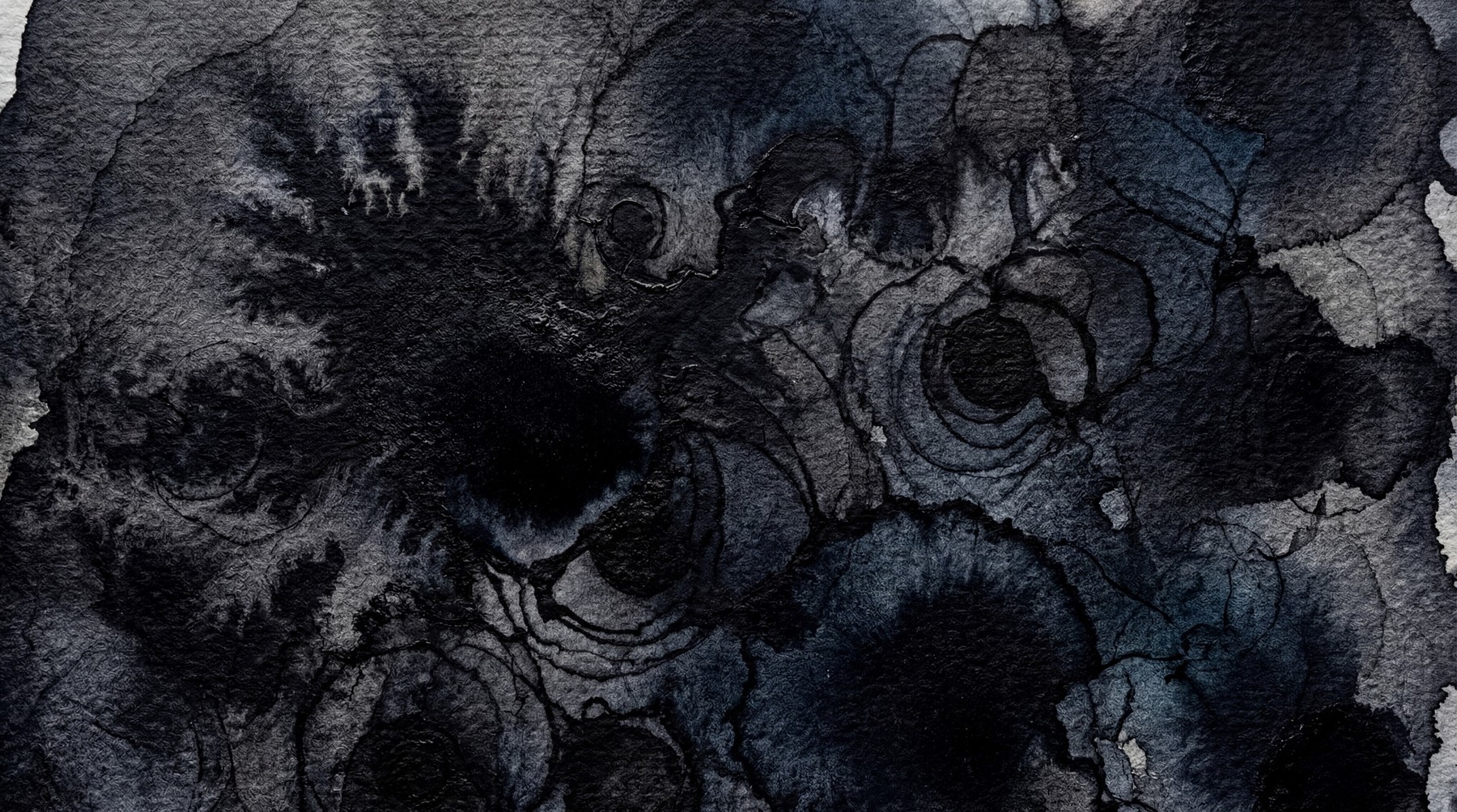Abstract watercolor and ink texture with dark gray and black hues, featuring swirling patterns and organic drips.