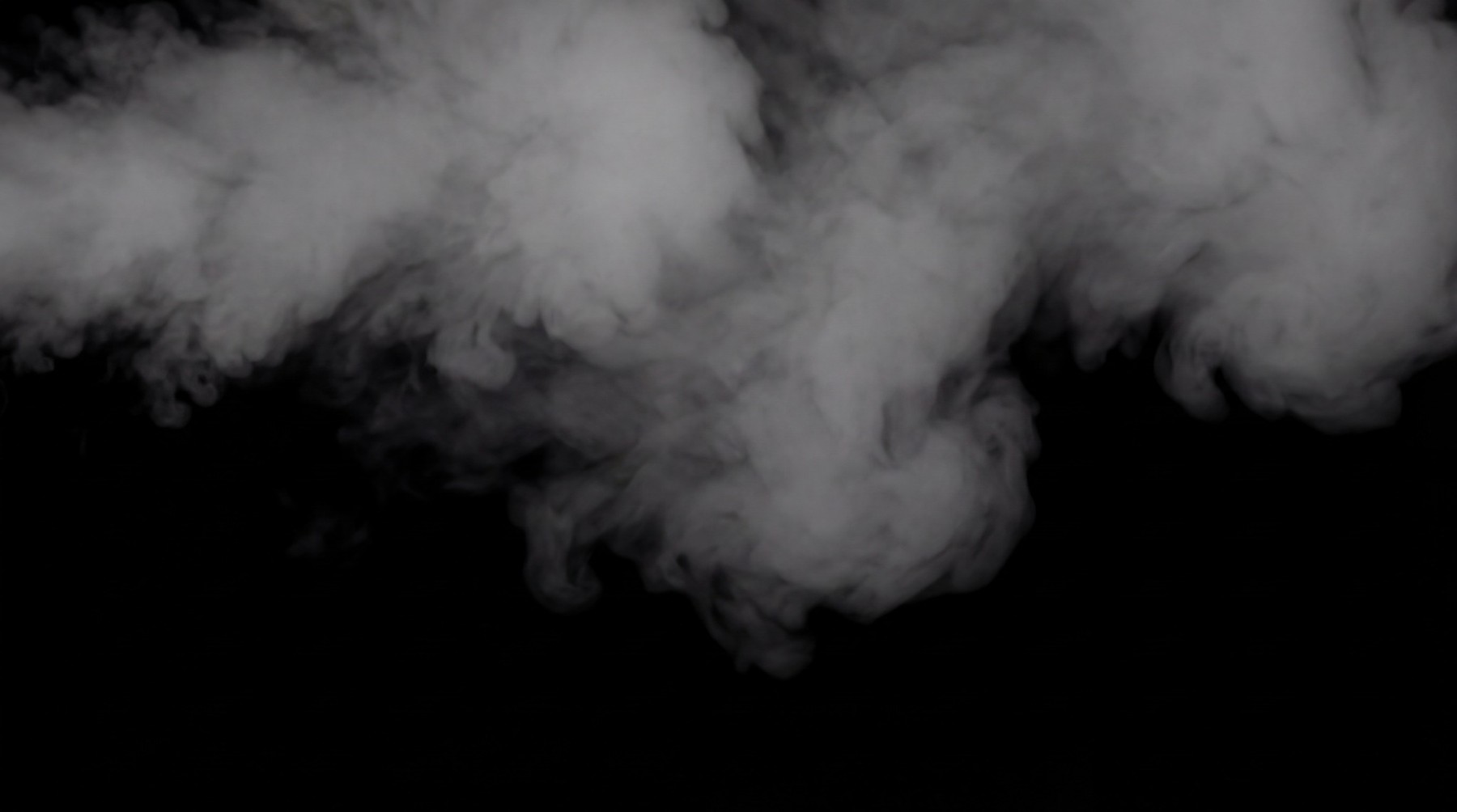 Ethereal wisps of white smoke drifting across a black background.